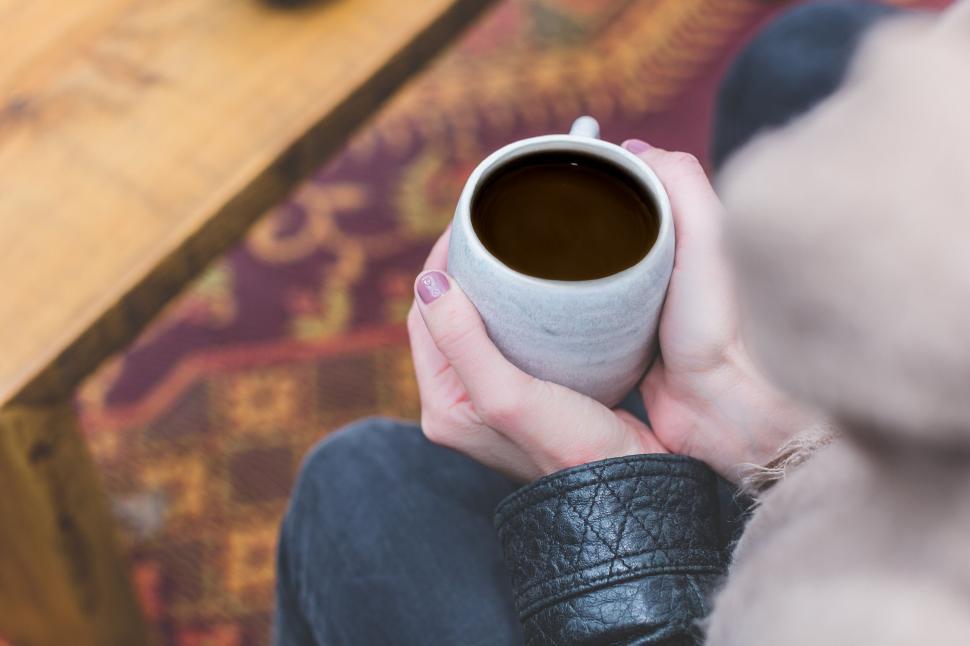 Free Image of Close-up of hands holding a cup of coffee 