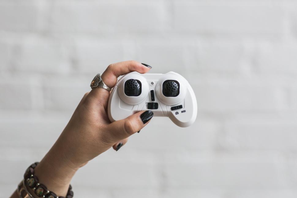 Free Image of Hand holding a white game controller 