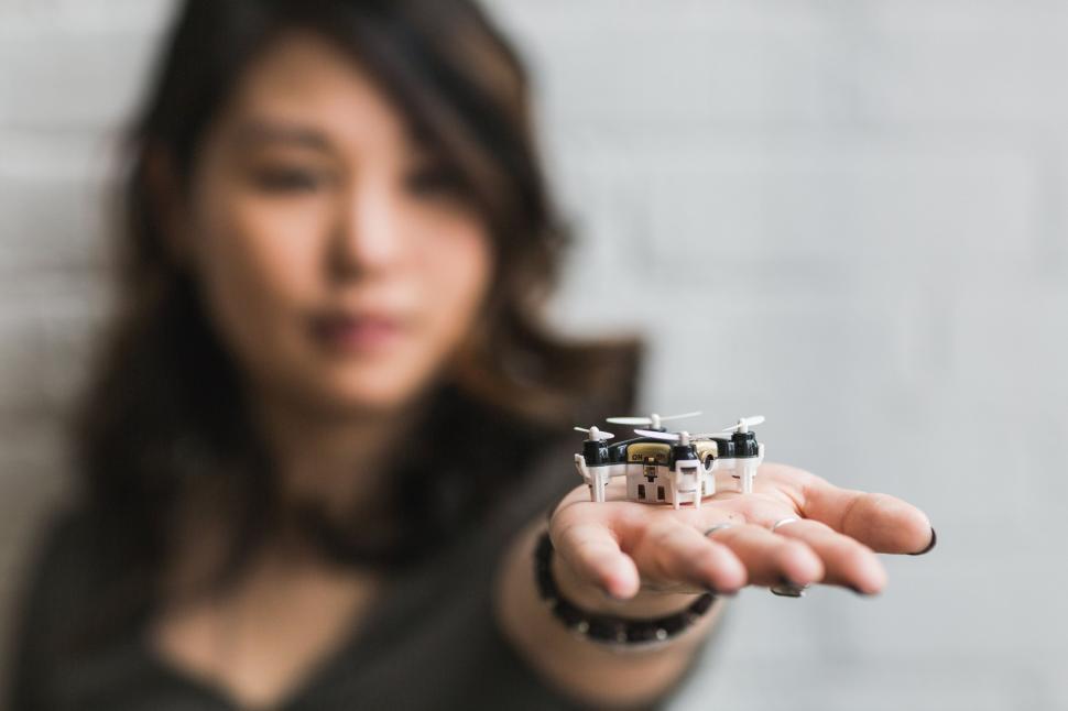 Free Image of Woman holding miniature drone palm 