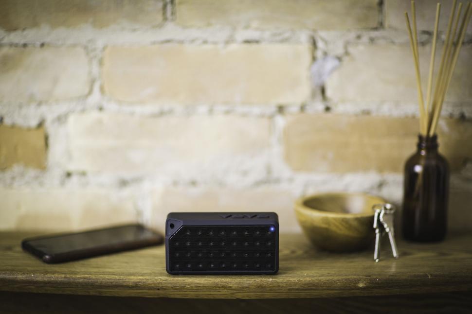 Free Image of Bluetooth speaker on a wooden shelf 