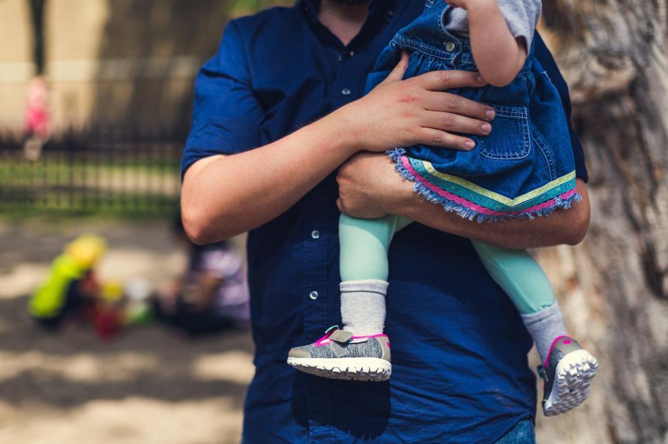 Free Image of Father holding young daughter at park 