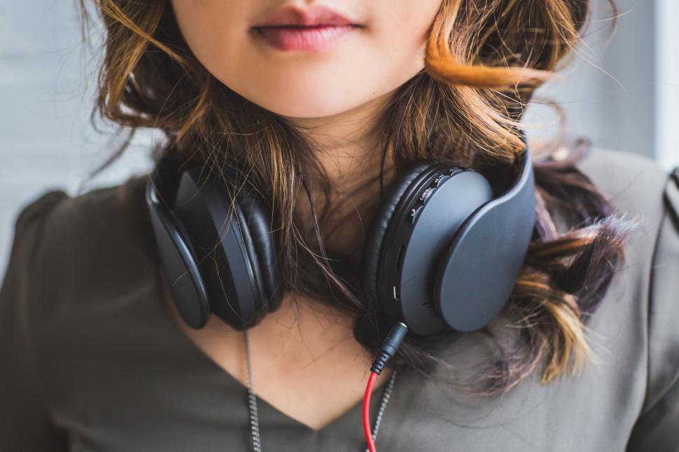 Free Image of Close-up of woman with headphones around neck 