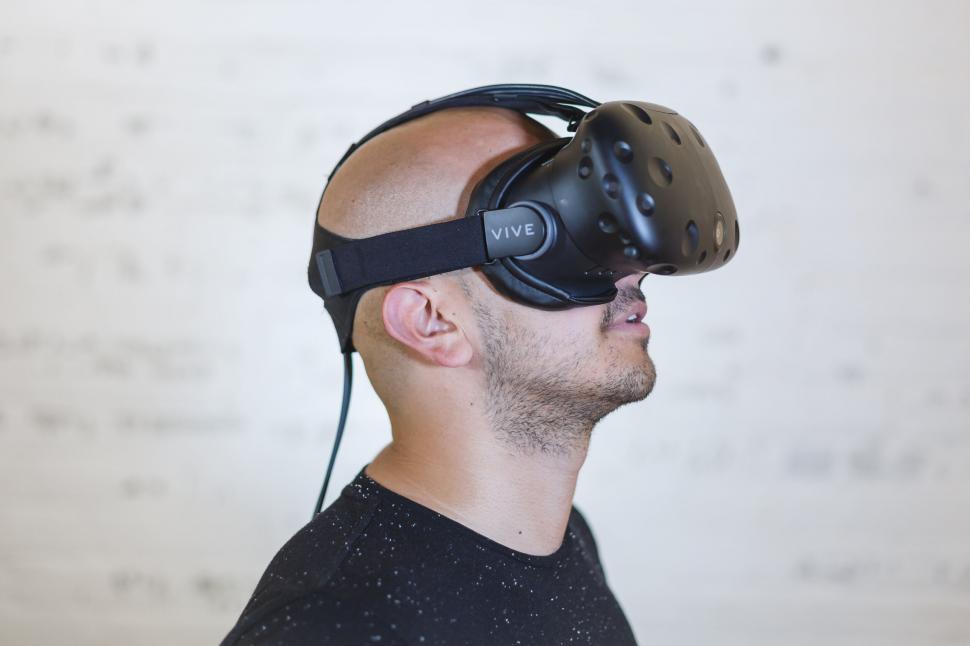 Free Image of Man wearing VR headset facing wall 