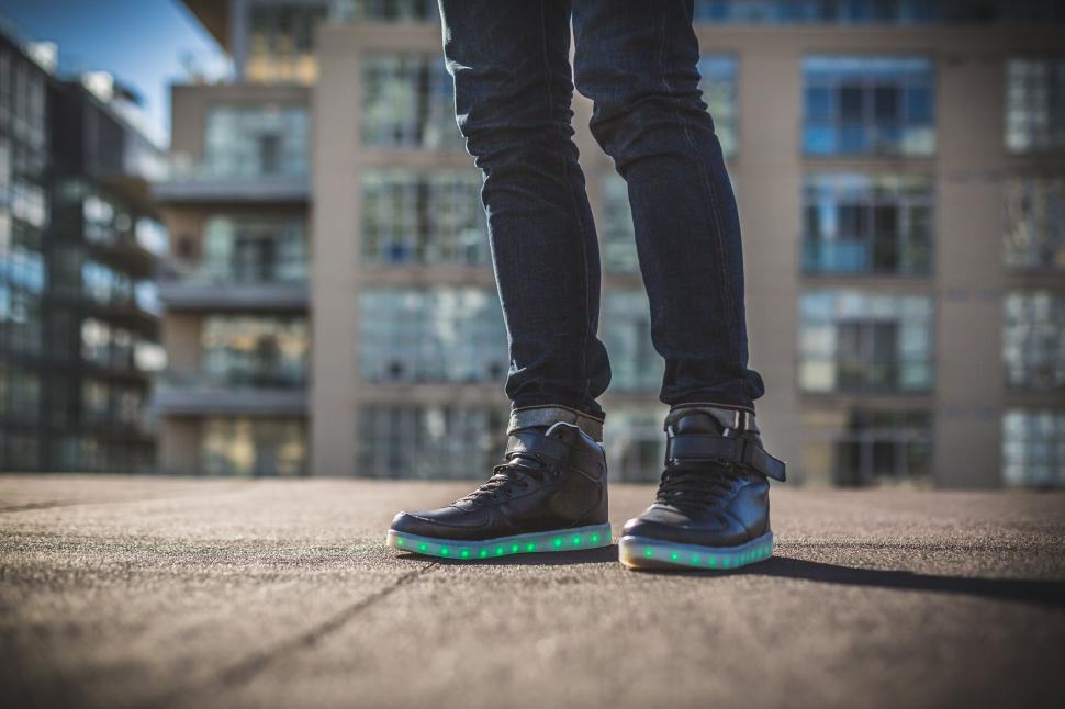 Free Image of Glowing sneakers on urban rooftop 