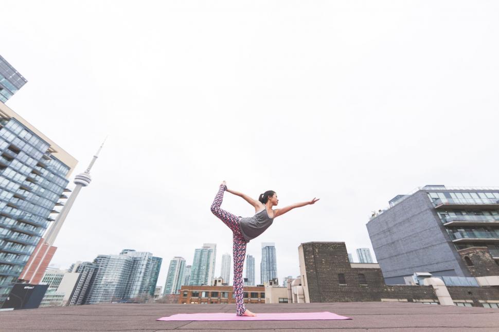 Free Image of Urban yoga practice with cityscape background 