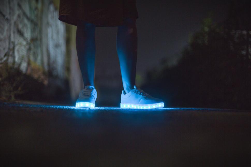 Free Image of Glowing shoes in the night on a person 