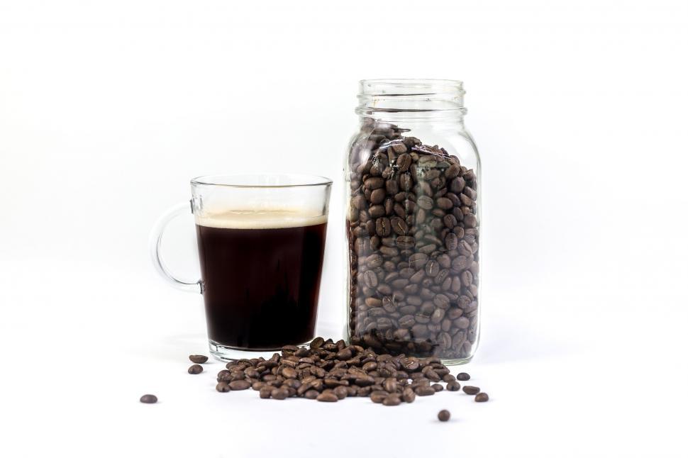 Free Image of Glass cup and jar filled with coffee beans on white 
