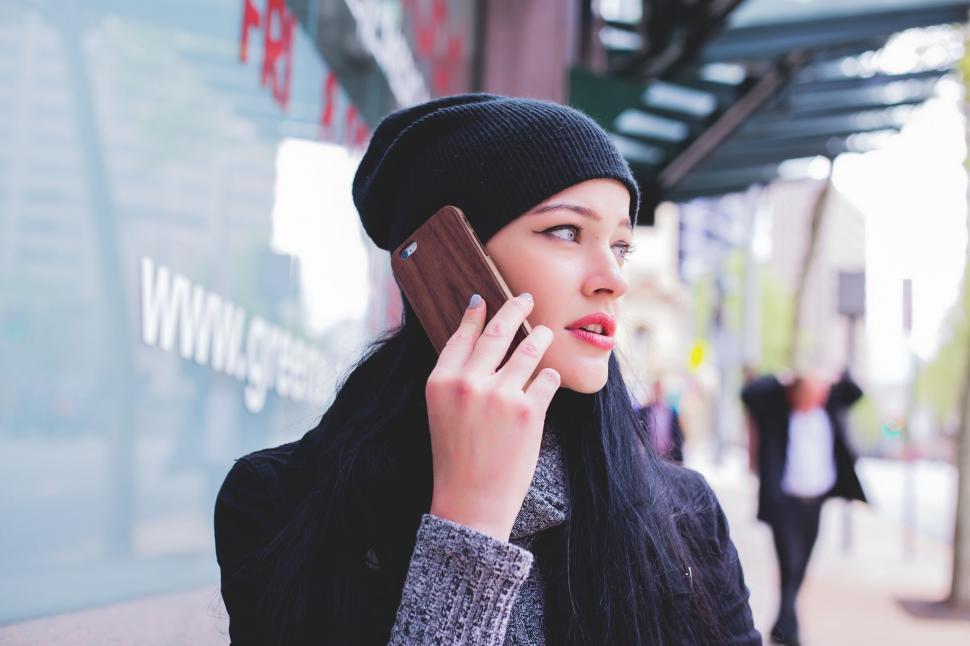 Free Image of Woman talking on phone in urban setting 
