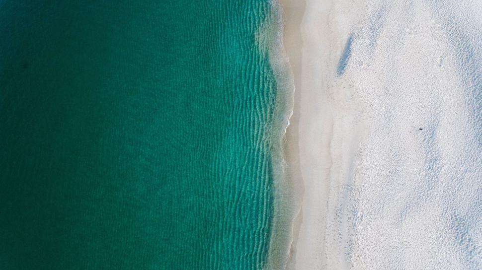 Free Image of Aerial view of a beach with clear water 