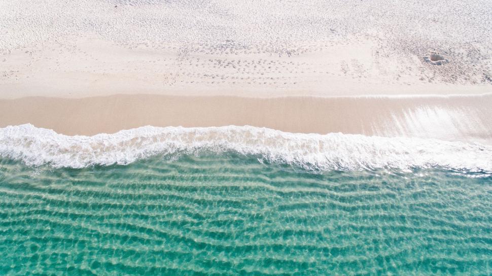 Free Image of Drone shot of gentle waves at the beach 