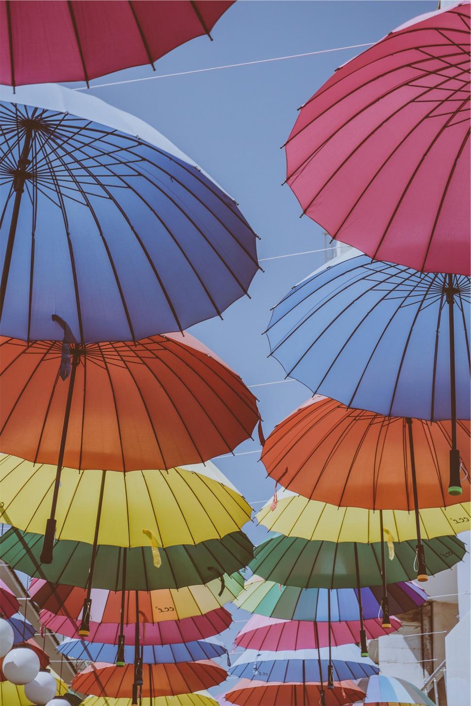 Free Image of Colorful umbrella canopy against blue sky 