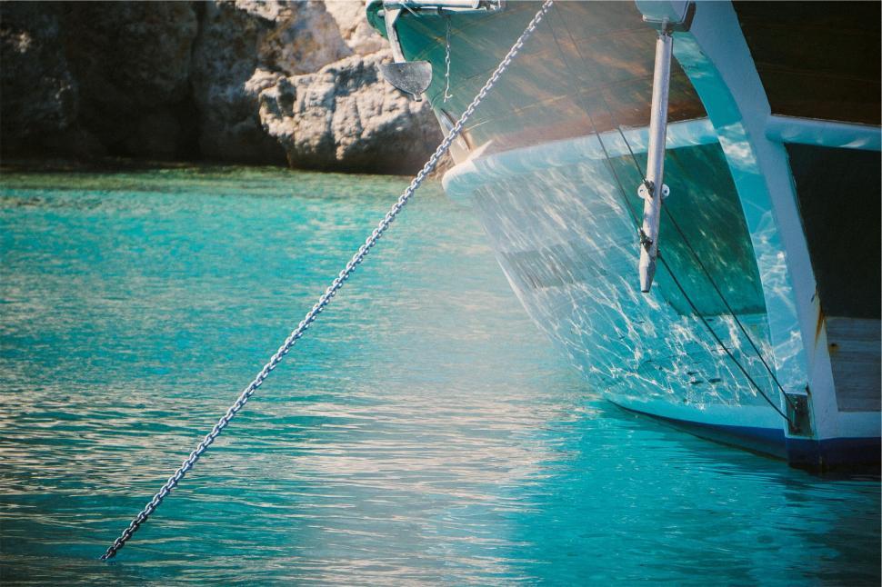 Free Image of Boat anchored in clear blue waters 
