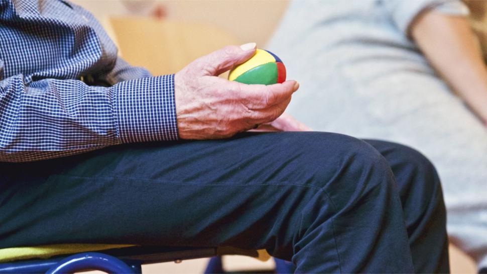 Free Image of Elderly hands holding a colorful ball 