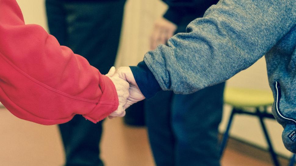 Free Image of Senior and young person holding hands 