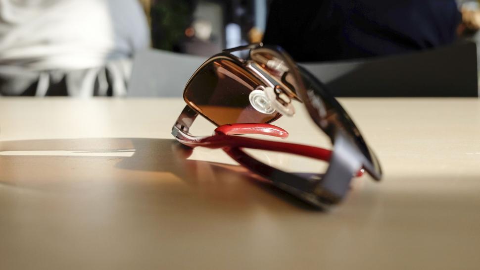 Free Image of Red sunglasses on a table in soft focus 