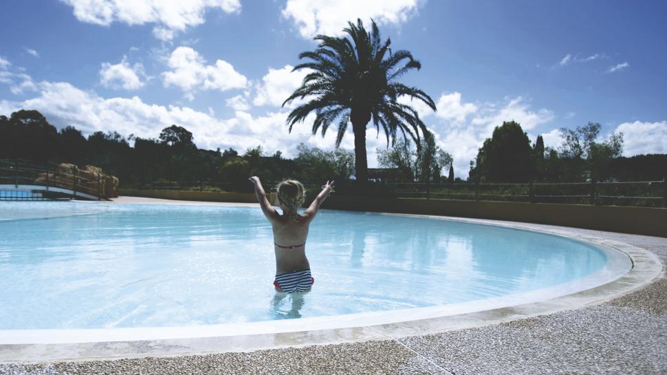Free Image of Boy enjoying swimming in an outdoor pool 