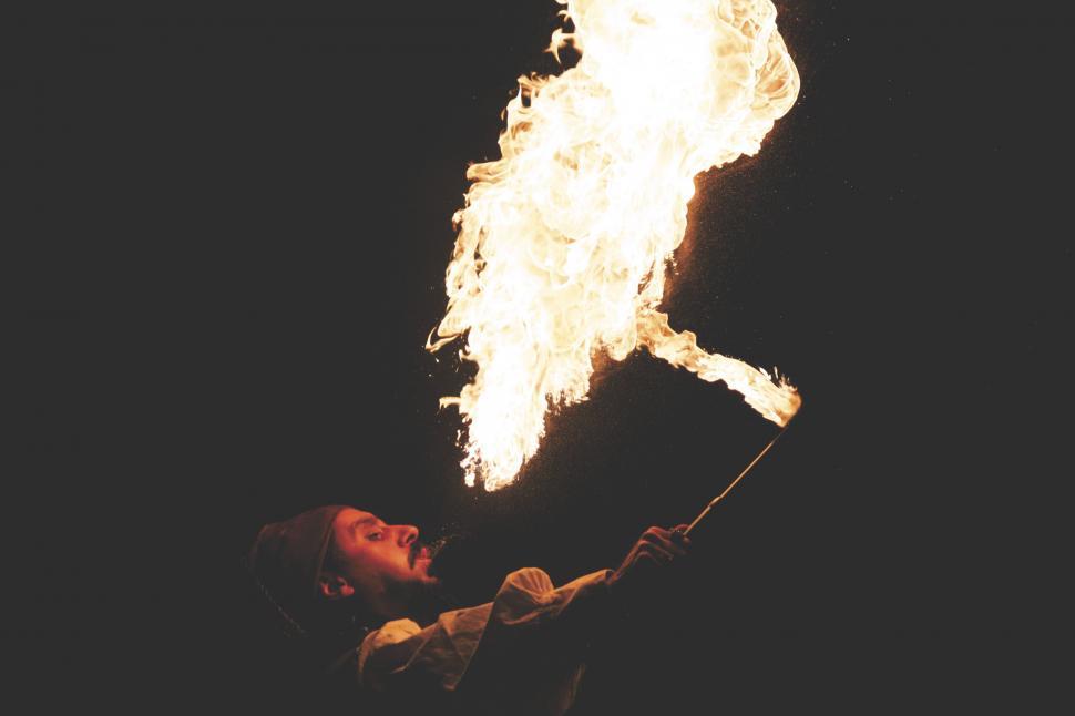 Free Image of Fire performer with blazing torch at night 