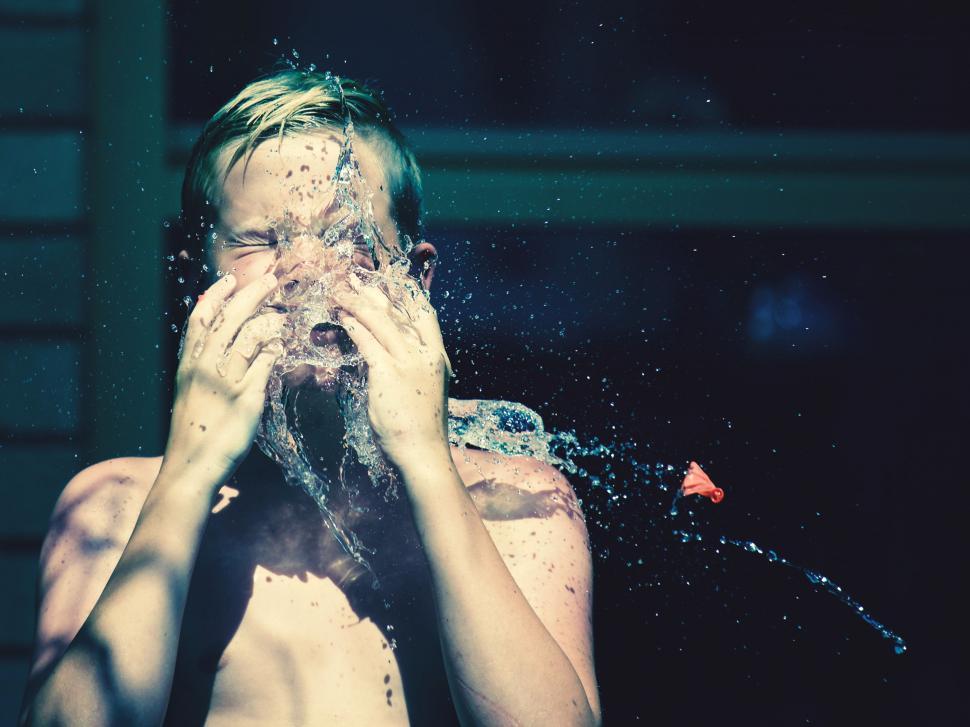 Free Image of Splashing water obscuring a woman s face 