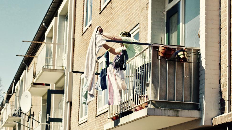 Free Image of Laundry hanging on a balcony in sunshine 