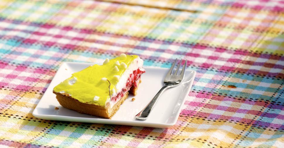 Free Image of Piece of cake on colorful picnic blanket 