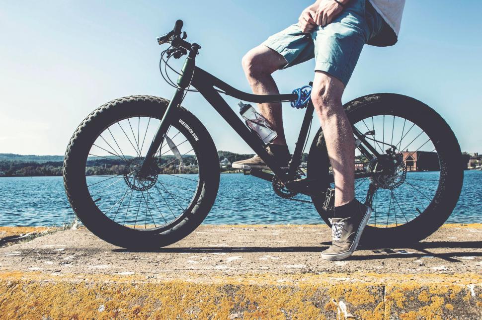 Free Image of Person riding a fat tire bike on dock 