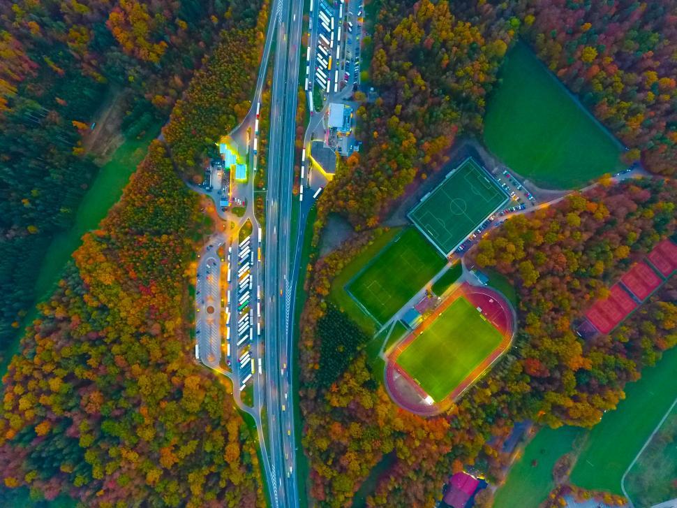 Free Image of Drone shot of highway and sports field in autumn 