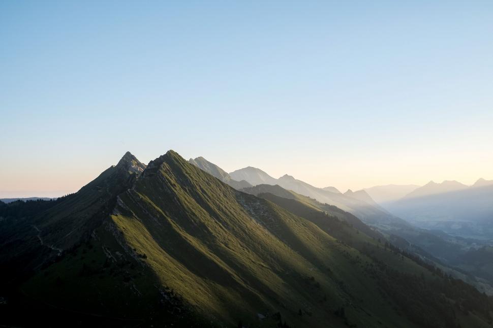 Free Image of Soft morning light hitting a mountain range 