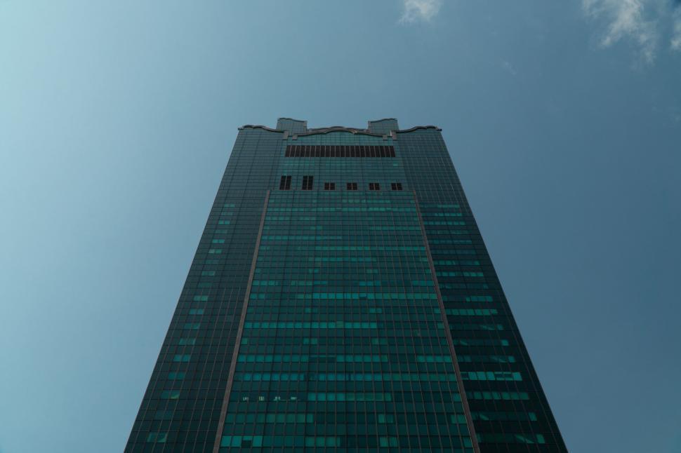 Free Image of Skyscraper reaching towards clear blue sky 