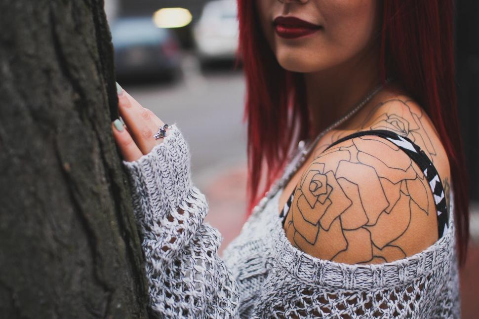 Free Image of Red-haired woman with large tattoos 