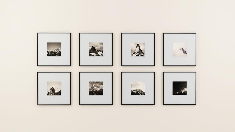 Free Image of Gallery wall with framed mountain photographs 