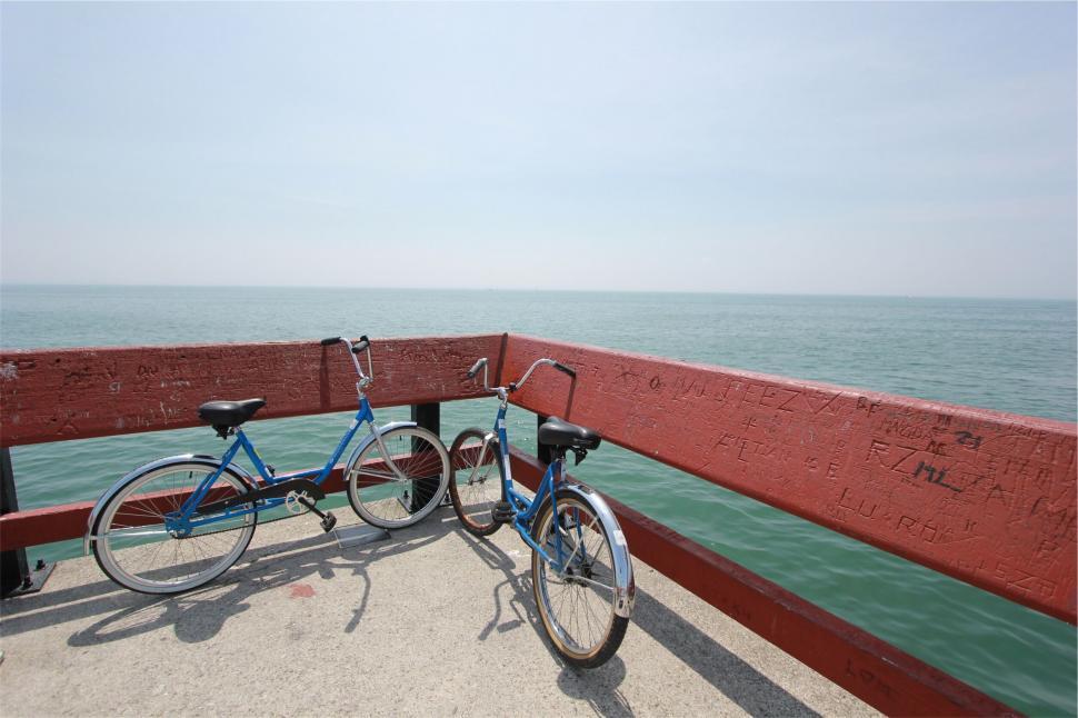Free Image of Bicycle parked on wooden pier over lake 