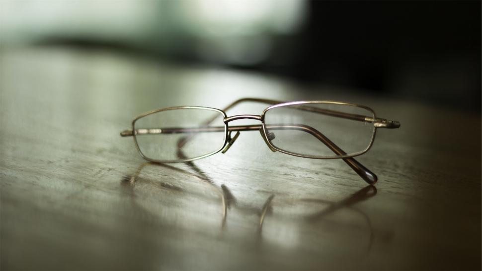 Free Image of Close-up of eyeglasses on a wooden table 