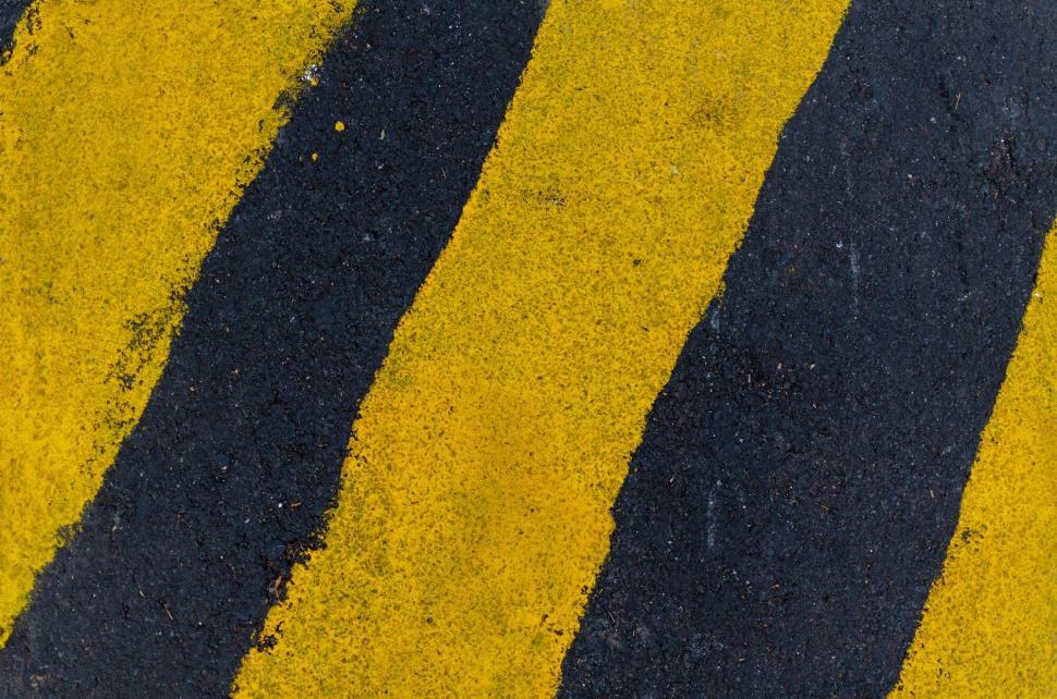 Free Image of Close up of yellow and black road markings 