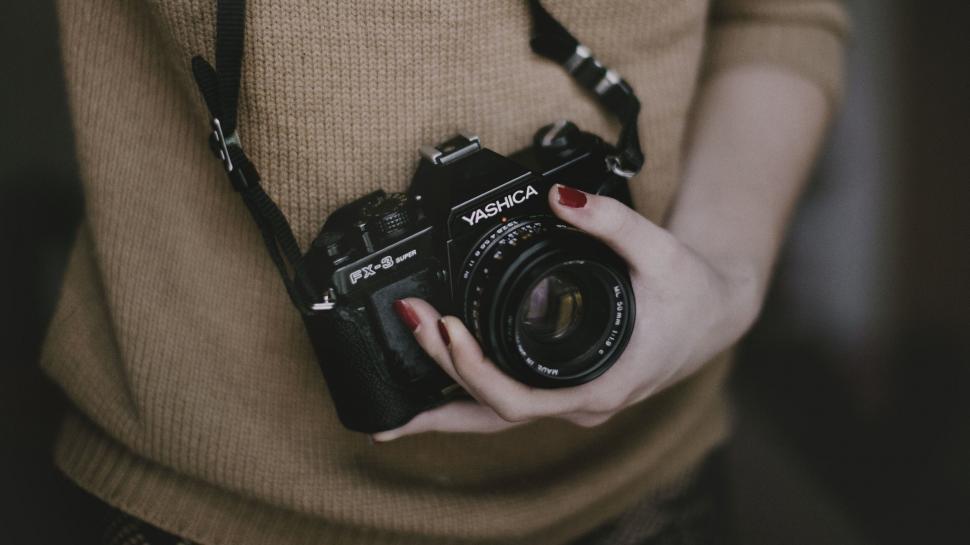 Free Image of Photographer holding a vintage camera 