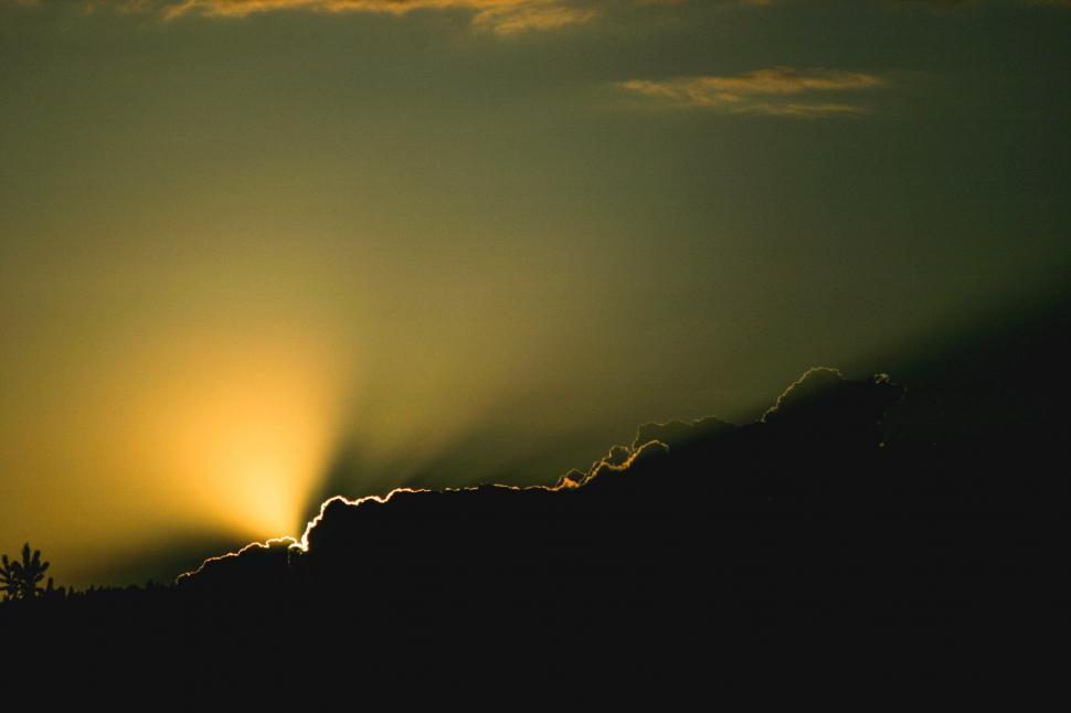 Free Image of Golden sunset behind cloud silhouette 