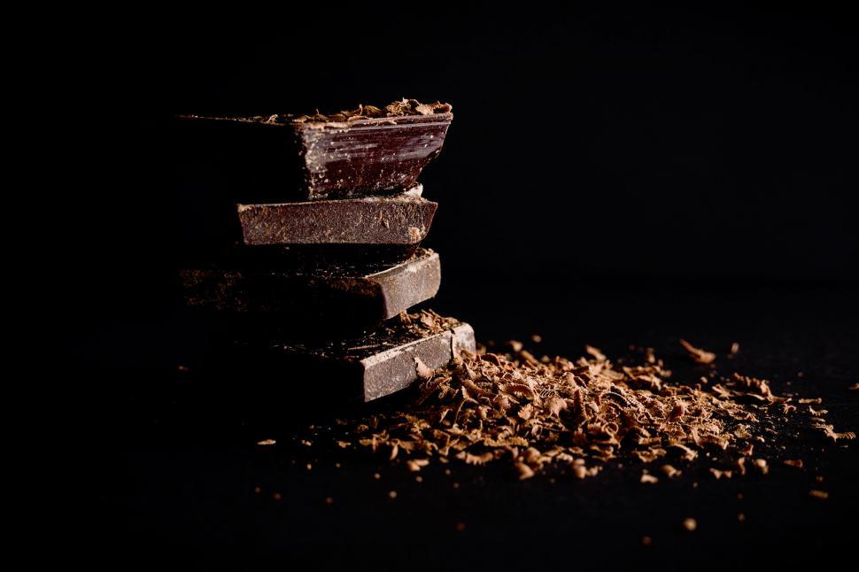 Free Image of Stack of dark chocolate pieces with shavings 