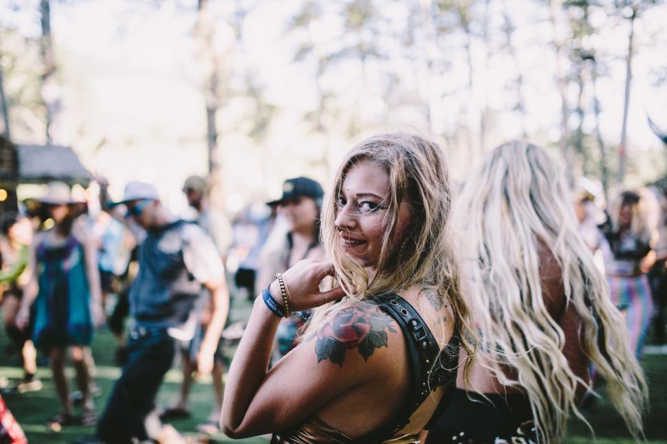 Free Image of Woman smiling at a music festival 