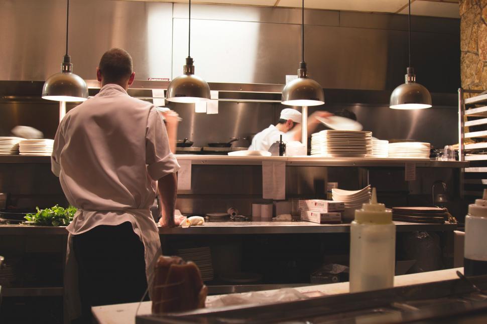 Free Image of Chefs working in a busy kitchen scene 