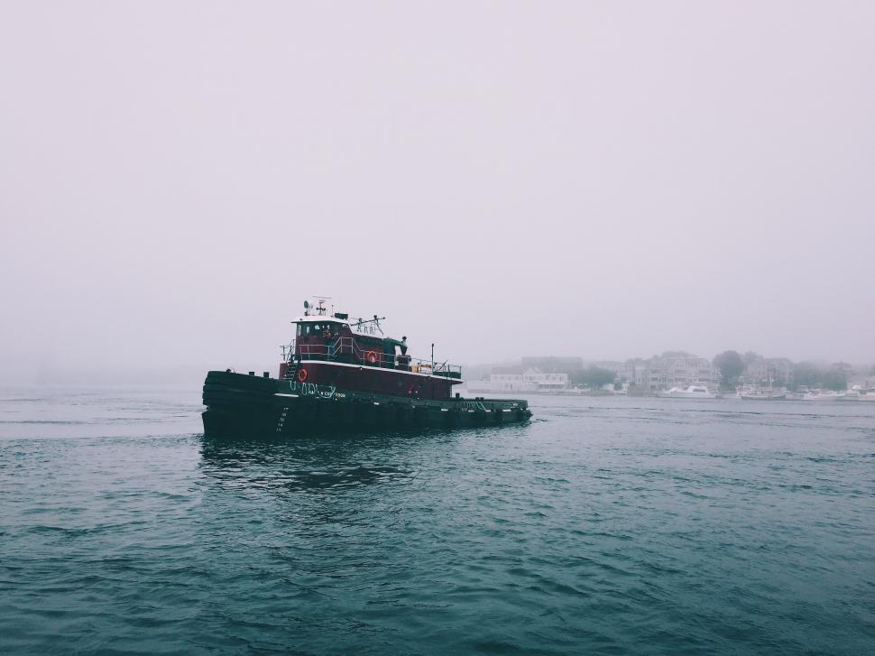 Free Image of Tugboat cruising in foggy waters 