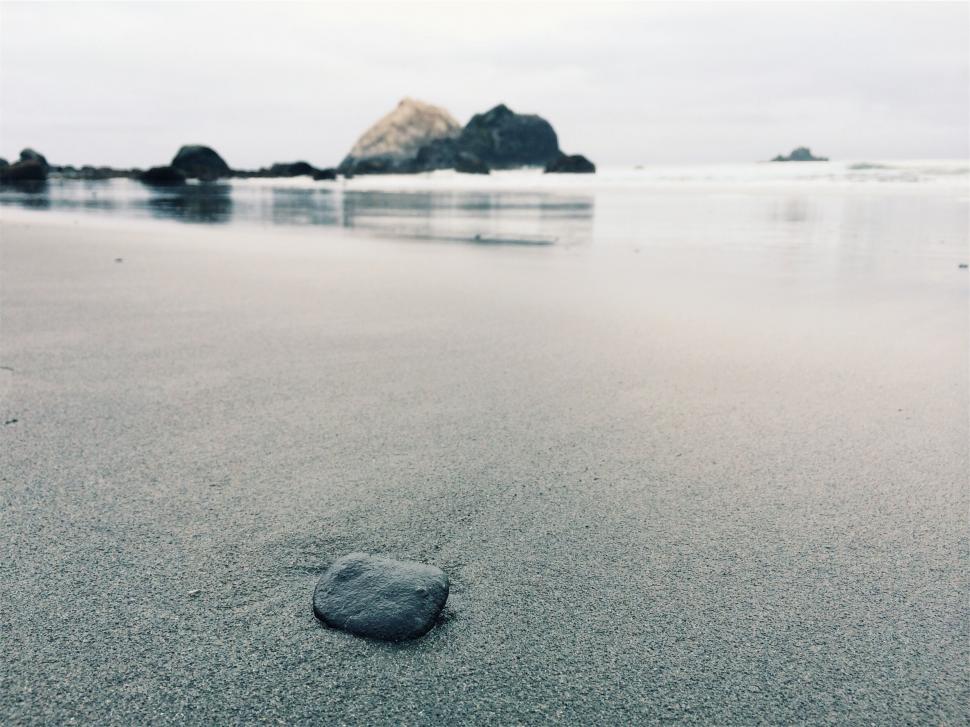 Free Image of Smooth stone on tranquil beach sands 