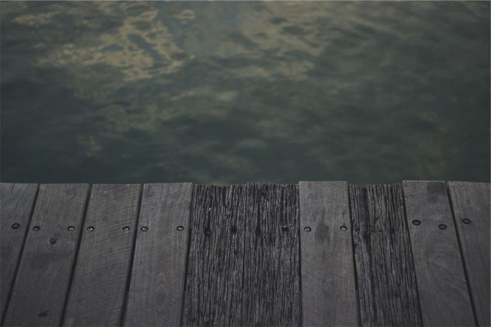 Free Image of Wooden Pier Overlapping Calm Waters 