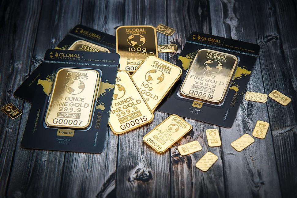 Free Image of Gold bars and coins on wooden surface 