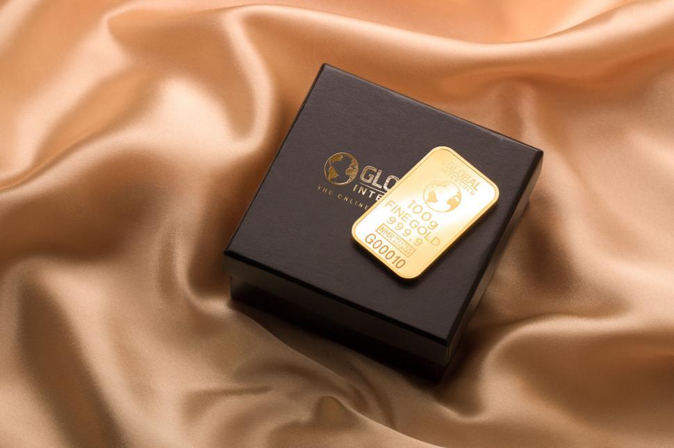 Free Image of Elegant packaging of a gold bar on silk 