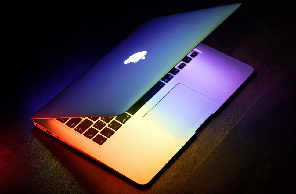 Free Image of Illuminated laptop on a dark background 