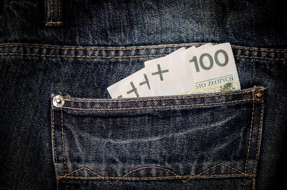 Free Image of Banknote protruding from denim pocket 
