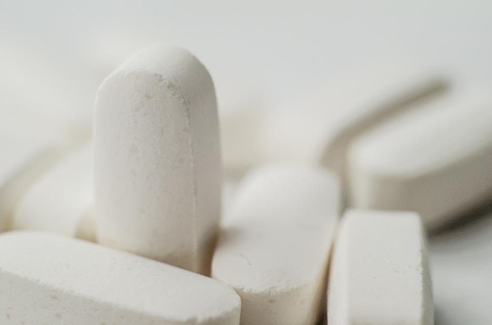 Free Image of Close-up of white tablets on white surface 