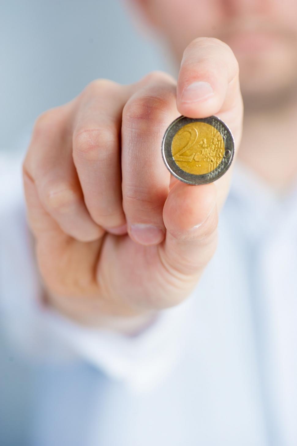 Free Image of Man holding a euro coin close up 
