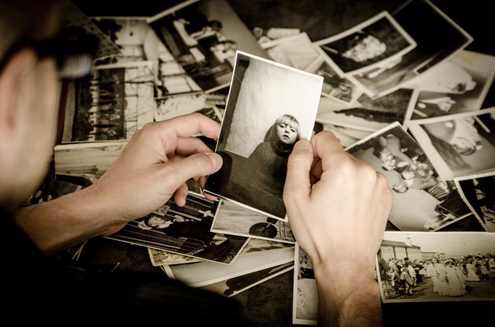 Free Image of Person holding a vintage photo among many 