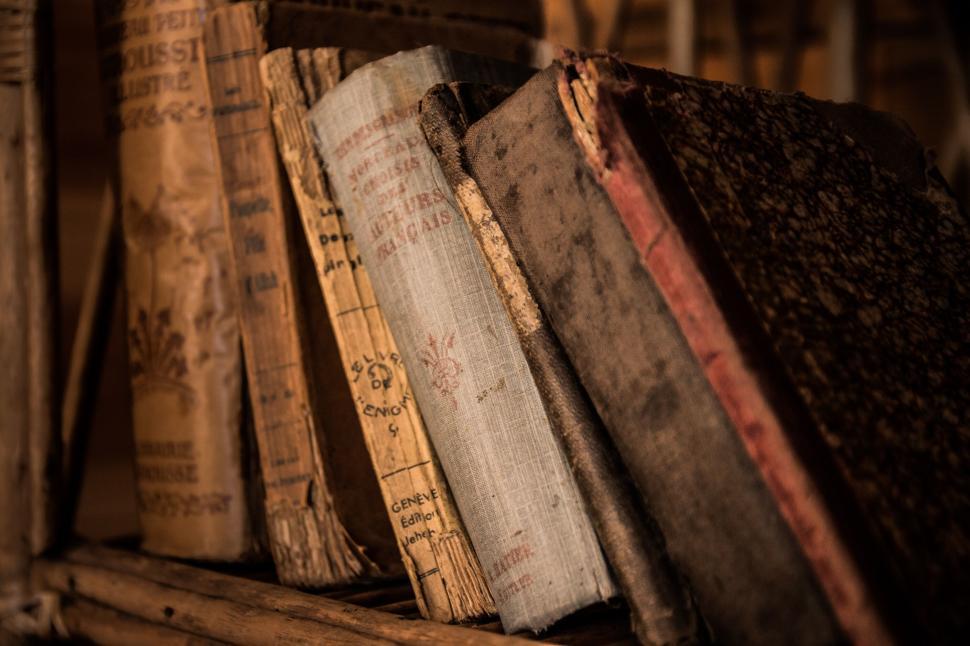 Free Image of Stack of vintage books on an old wooden shelf 