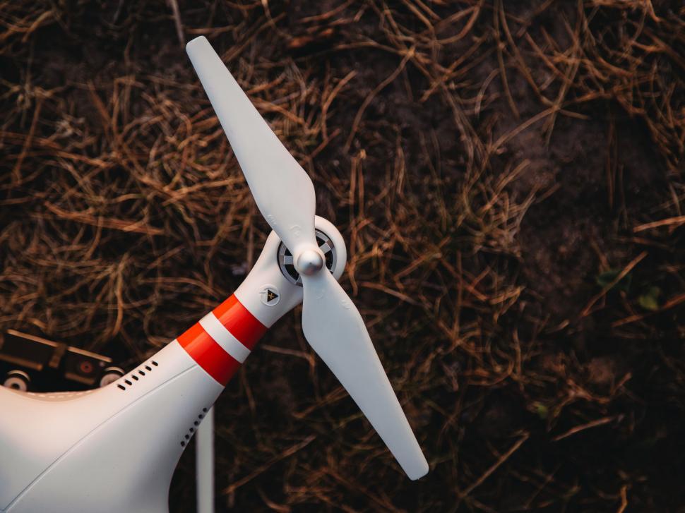 Free Image of Close-up of a white drone propeller on ground 